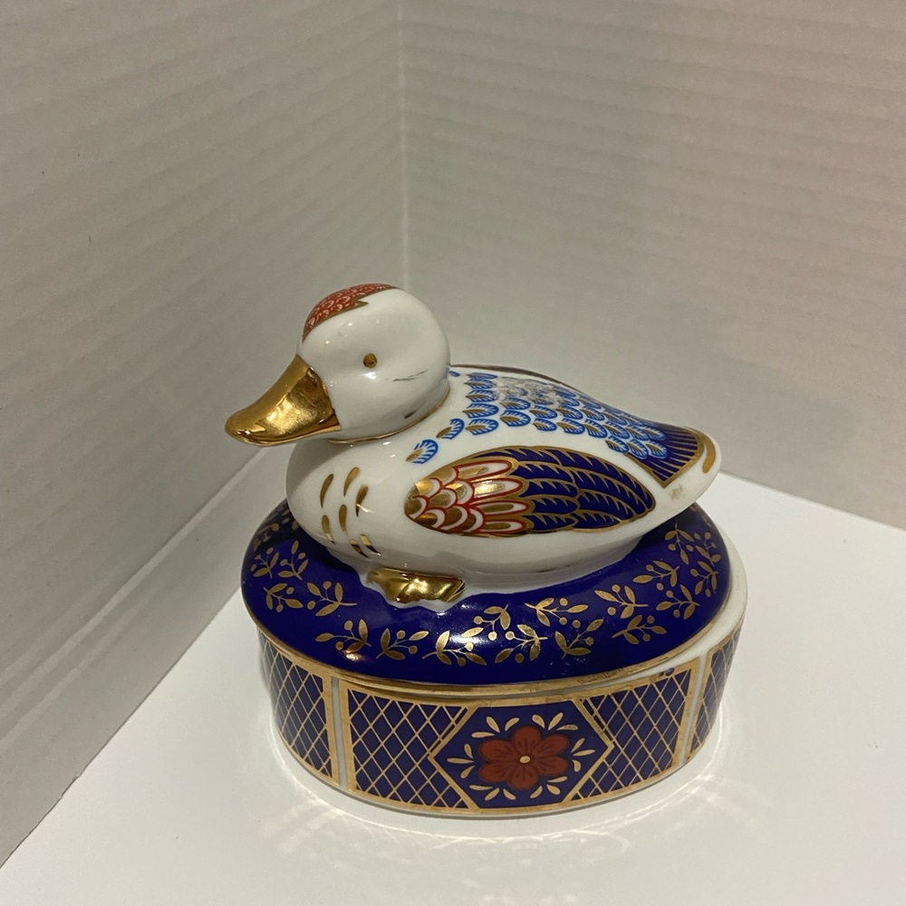 Adorable cobalt blue and multicolored duck trinket box.